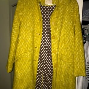 it is a yellow coat with the interior like a brown-ish with white dots